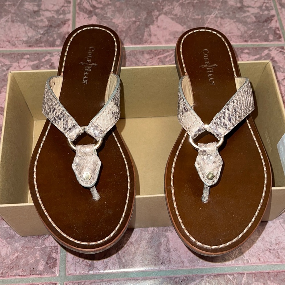 Cole Haan woman’s slippers with gold accent.